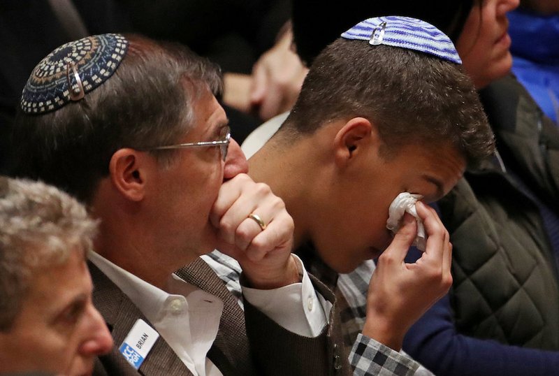 People mourn during a memorial service at the Sailors and Soldiers Memorial Hall of the University of Pittsburgh Oct. 28