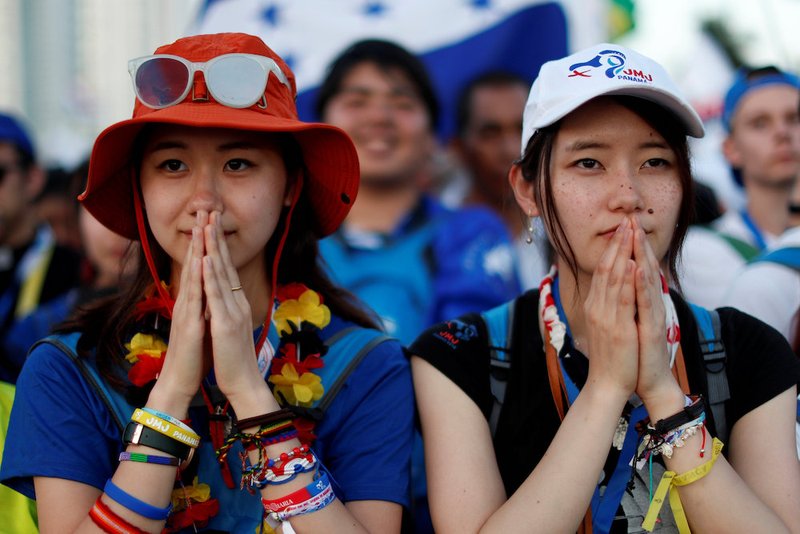 Pilgrims pray during the opening Mass of World Youth Day in Panama City Jan. 22