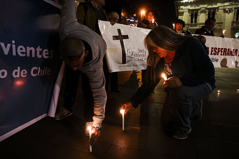 People place candles in front of the Metropolitan Cathedral of Santiago Aug. 20 during a demonstration against sexual abuse committed in the Chilean Catholic Church. (CNS photo/Alberto Pena