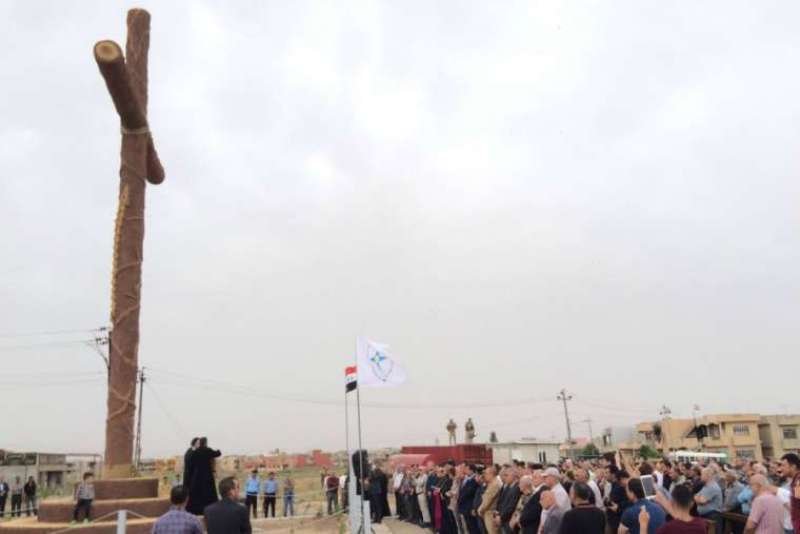 Syrian Catholic Archbishop Youhanna Boutros Moshe of Mosul blesses a newly-erected cross in Bakhdida