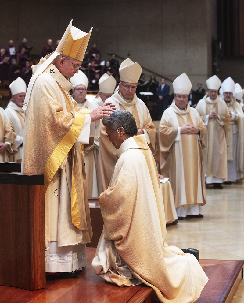 Archbishop Gomez lays his hands on Bishop Alex Aclan at his episcopal ordination Mass May 16