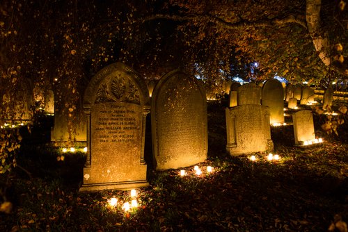 Candles are lit in the cemetery at St. Peter's Church in Hope