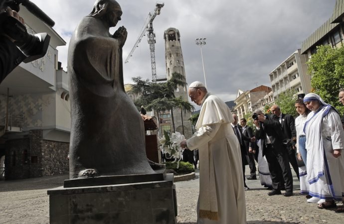 Pope Francis leaves flowers in front of a statue at the Mother Teresa memorial in Skopje