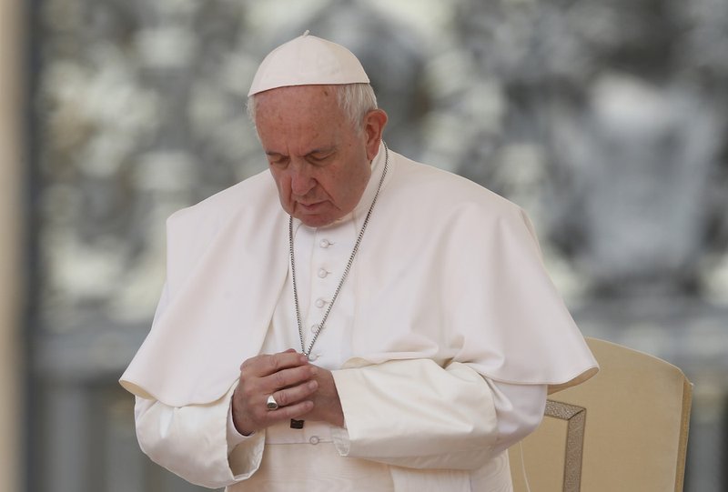 Pope Francis prays during his general audience in St. Peter's Square at the Vatican May 22