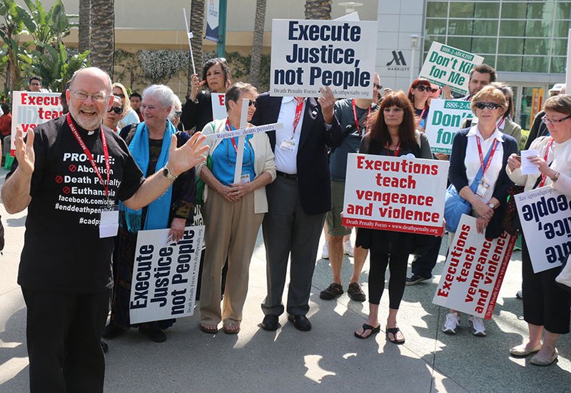 Father Chris Ponnet leads a demonstration against the death penalty Feb. 27 as part of the Los Angeles Religious Education Congress in Anaheim