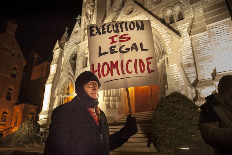 A man protests during a vigil held outside St. Louis University College Church ahead of the 2014 execution of death-row inmate Herbert Smulls of St. Louis. The revision to section 2267 in the Catechism of the Catholic Church
