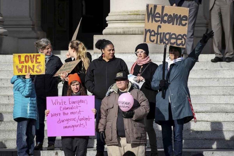 People gather Nov. 20, 2015, outside the Washington Capitol in Olympia to urge the United States accept Syrian refugees. In a Sept. 13 statement, Cardinal Daniel N. DiNardo of Galveston-Houston, president of the U.S. Conference of Catholic Bishops, and Bishop Joe S. Vasquez of Austin, Texas, chairman of the USCCB Committee on Migration, urged the Trump administration to reject further reductions in the number of refugees to be admitted to the U.S. in the coming year. (CNS photo/David Ryder, Reuters)