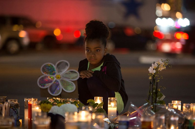A girl looks at a makeshift memorial Oct. 4 for victims of a mass shooting along the Las Vegas Strip. (CNS photo/Steve Marcus