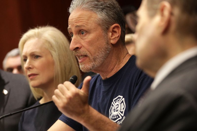 Former 'The Daily Show' host Jon Stewart speaks as U.S. Sen. Kirsten Gillibrand (D-NY) listens during a news conference Feb. 25