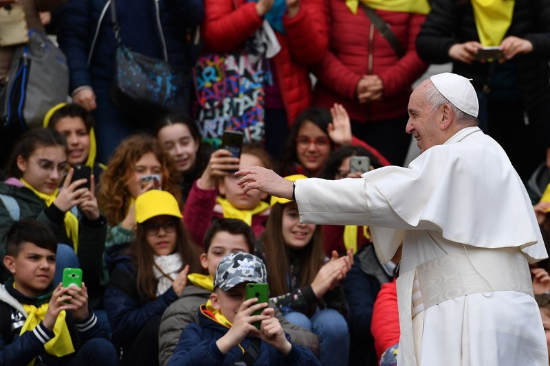 Children with their mobile phones take photos of Pope Francis at the end of the weekly general audience on April 3 at St. Peter's square in the Vatican. (ALBERTO PIZZOLI/AFP/GETTY IMAGES)