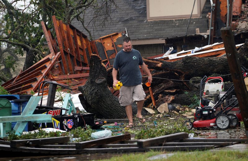 Tim Freiberg walks through debris of his destroyed garage Aug. 26 after Hurricane Harvey struck Rockport