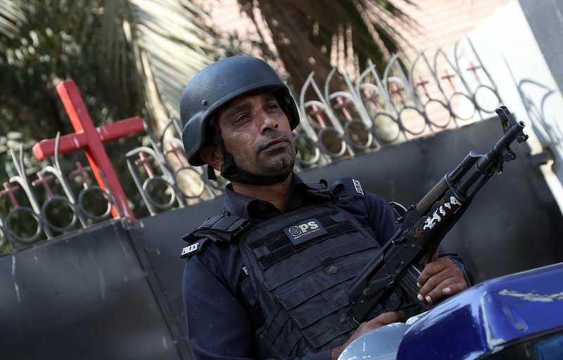 An armed guard stands guard outside St. Andrew Church in Karachi