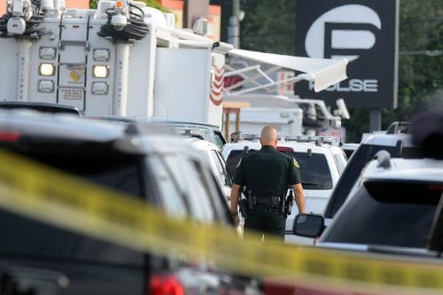 Orlando police officers seen outside of Pulse nightclub after a fatal shooting and hostage situation on June 12