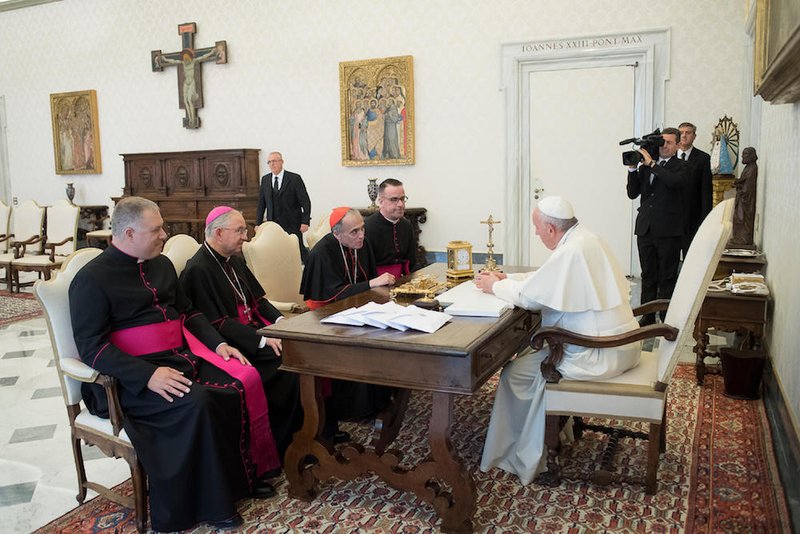 Pope Francis talks with officials of the U.S. Conference of Catholic Bishops during a private meeting Oct. 9 at the Vatican. Pictured are Msgr. Jeffrey D. Burrill