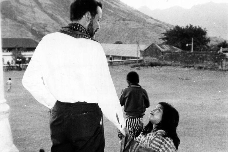 Father Rother andl ittle girl. (Credit: Frankie Williams/Courtesy of the Archdiocese of Oklahoma City Archives)