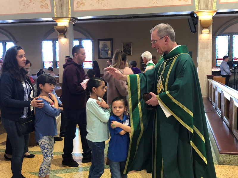 Bishop Marc Trudeau blesses the children in the communion line during the Family Mass at St. Joseph Church on Jan. 26.