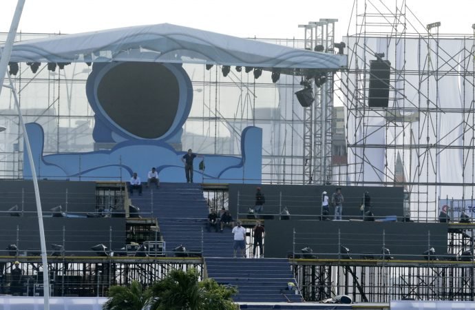 Workers stand on the stage that will be used by Pope Francis during the opening of World Youth Day in Panama City