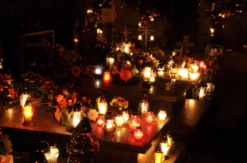 Candle flames illuminating a cemetery during All Saints' Day. (Shutterstock.com)