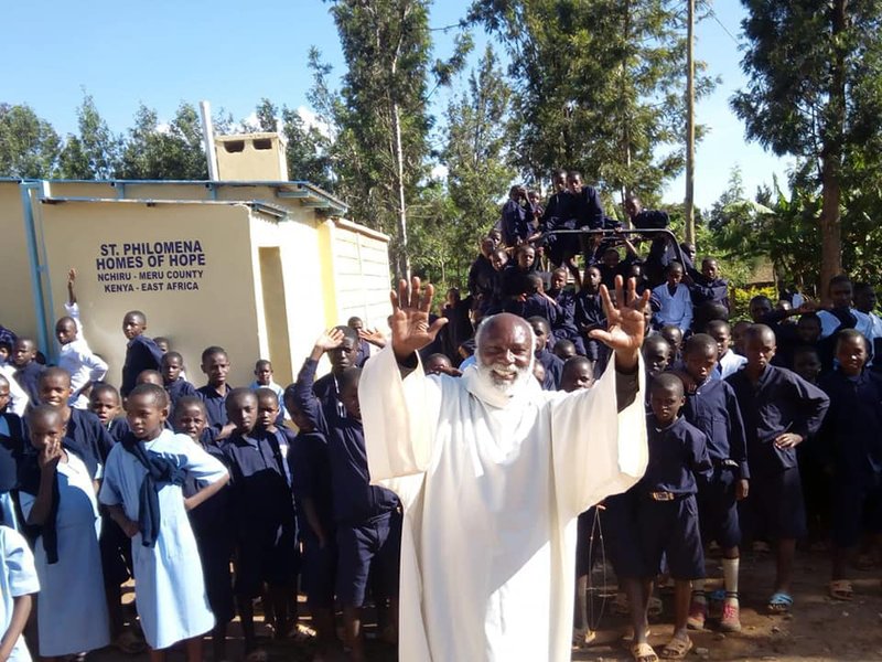 Father Francis Riwa gestures in late August at Nchiru Catholic Parish in northeastern Kenya when he commissioned a new dormitory for children living with HIV. Father Riwa
