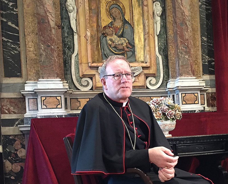 Auxiliary Bishop Robert E. Barron of Los Angeles speaks to reporters March 7