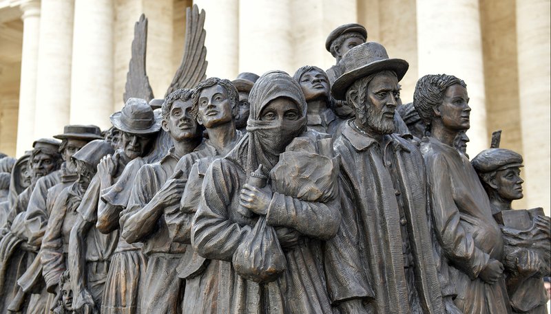 Migrants and refugees are pictured on a large bronze statue in St. Peter's Square at the Vatican Sept. 29, 2019. Pope Francis attended the unveiling of the statue after celebrating a Mass for World Day of Migrants and Refugees. (CNS photo/Paolo Galosi, pool)