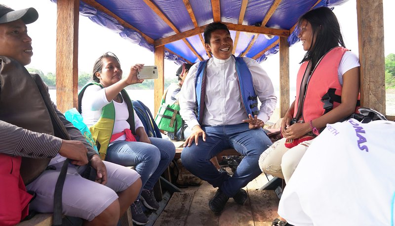 Deacon Ferney Pereira and members of his Colombian parish take a boat on a river in the Amazon Sept. 8, 2019. (CNS photo/Manuel Rueda)