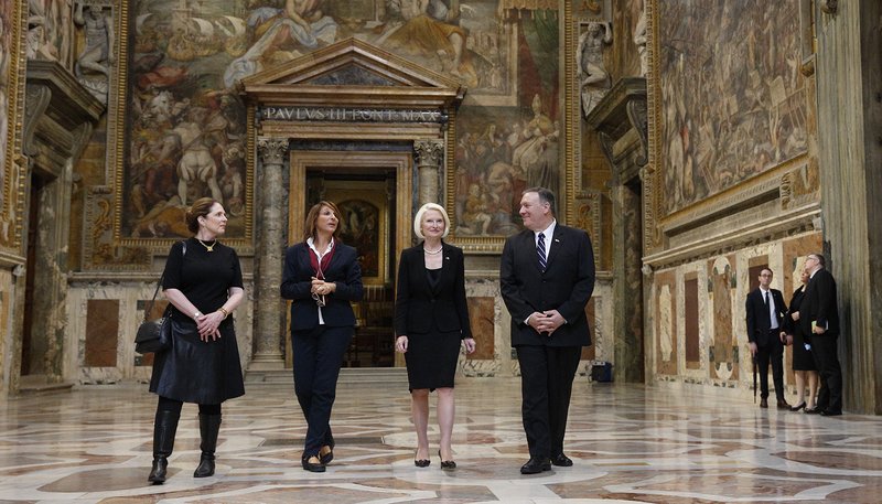 U.S. Secretary of State Mike Pompeo, his wife Susan, left, and Callista Gingrich, U.S. ambassador to the Vatican, walk with a tour guide as they visit the Sala Regia at the Vatican Oct. 2, 2019. Secretary of State Pompeo toured the Vatican after speaking at a symposium sponsored by the U.S. Embassy to the Holy See at the Vatican. The symposium focused on areas of collaboration between the U.S. and the Vatican including the causes of advancing religious freedom and fighting against human trafficking. (CNS photo/Paul Haring)