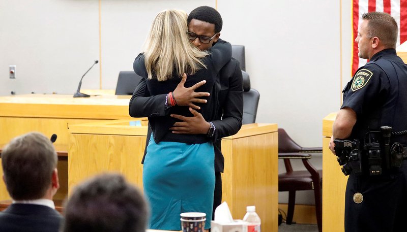 Brandt Jean, the younger brother of murder victim Botham Jean, hugs former Dallas police officer Amber Guyger after delivering his impact statement to Guyger at the Frank Crowley Courts Building in Dallas following her Oct. 2, 2019, sentencing to 10 years in prison for murdering Botham. (CNS photo/Tom Fox pool via Reuters)