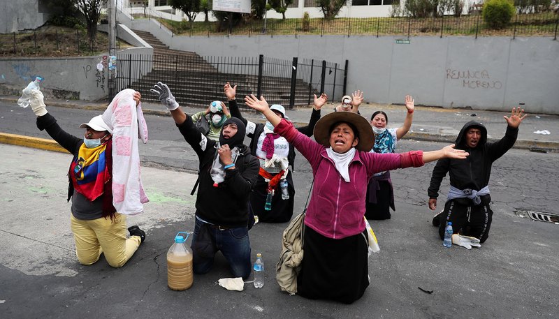 Demonstrators kneel down during a protest against Ecuadorian President Lenin Moreno's austerity measures in Quito, Ecuador, Oct. 11, 2019. Ecuadorian observers at the Synod of Bishops for the Amazon at the Vatican are keeping an eye on massive protests that have claimed the lives of at least five people in their country. (CNS photo/Ivan Alvarado, Reuters)