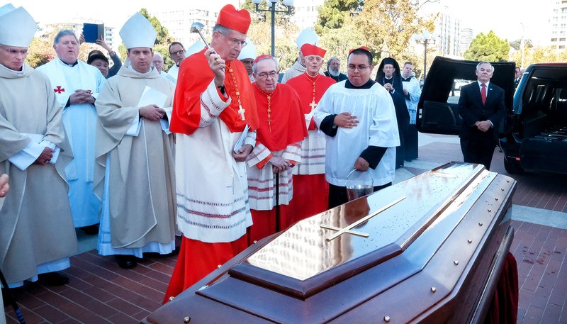 Cardinal Roger M. Mahony, retired archbishop of Los Angeles, blesses the casket of Cardinal William J. Levada Oct. 24, 2019, on the plaza at St. Mary's Cathedral in San Francisco after the cardinal's funeral Mass. Cardinal Levada, who died unexpectedly Sept. 26, was remembered by homilist Archbishop John C. Wester of Santa Fe, N.M, for his love for the church. (CNS photo/Dennis Callahan, Catholic San Francisco)