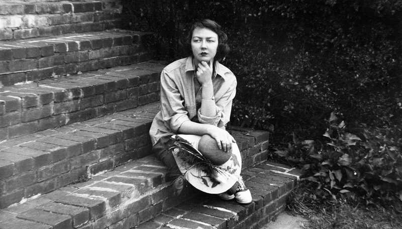 Catholic writer Flannery O'Connor is seen in a Sept. 22, 1959, photo, sitting on the steps of her home in Milledgeville, Ga. Elizabeth Coffman, an associate professor of film and digital media at Loyola University Chicago, co-directed the 2019 documentary "Flannery" with Jesuit Father Mark Bosco, vice president for mission and ministry at Georgetown University in Washington. The film, about the life and writings of O'Connor, recently won the Library of Congress Lavine/Ken Burns Prize for Film. (CNS photo/Floyd Jillson/Atlanta Journal-Constition, via AP, courtesy "Flannery")