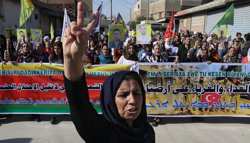 Kurdish and Arab protesters chant slogans against Turkish President Recep Tayyip Erdogan as they walk during a march to U.N. headquarters in Qamishli, Syria, Oct. 23, 2019. People in northeastern Syria say despite Erdogan's reassurances, the Turkish military and its allied Syrian armed groups are persecuting religious minorities. (CNS photo/Muhammad Hamed Reuters)