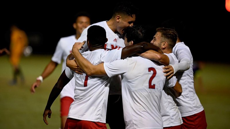 LMU players celebrate the double-overtime game-winner by Bastien Oberli in a 2-1 win over Portland Oct. 19. (LMU Athletics)