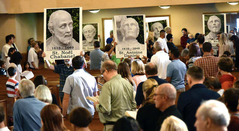Parishioners process into Mass at American Martyrs Church in Manhattan Beach Oct. 20, 2019 (World Mission Sunday) with poster-sized images of the North American Martyrs. (Bob Visty)