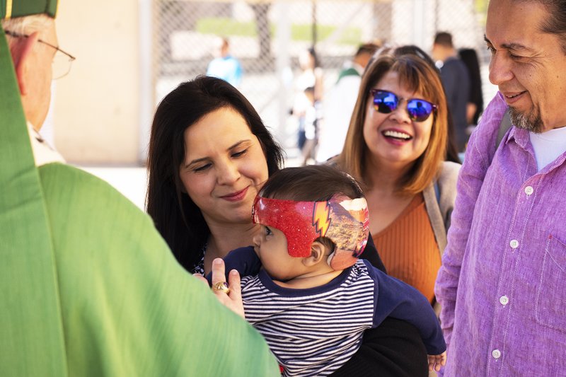 Archbishop Gomez blesses a child at Sunday's Catholics Love Foster event. (Victor Alemán)