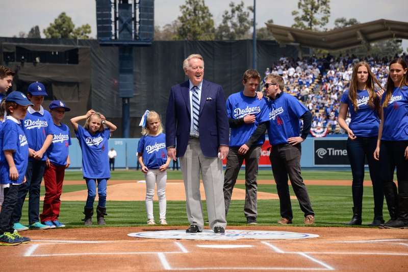 Vin Scully stands in front of his grandchildren during opening day pre game ceremonies at a baseball game between the San Fransisco Giants and the Los Angeles Dodgers at Dodger Stadium on April 4, 2014 in Los Angeles, California. (Photo by Noel Vasquez/Getty Images)