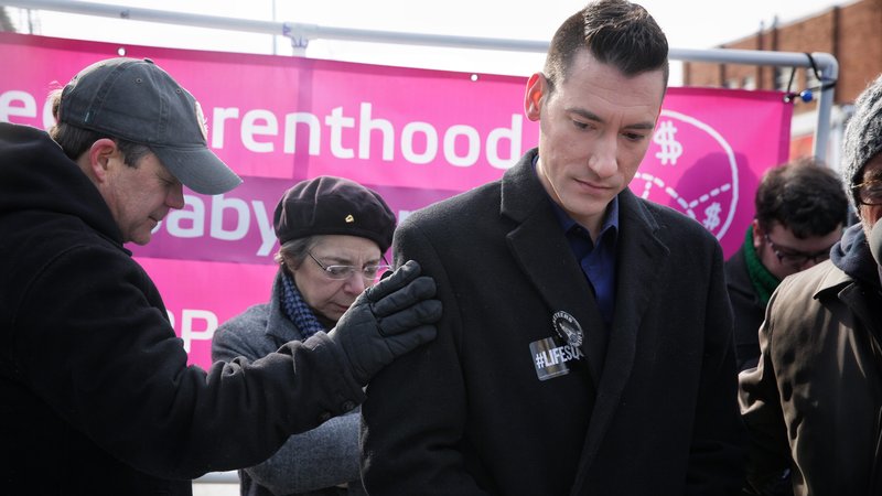 A man comforts David Daleiden, founder of the Center for Medical Progress, during a prayer and protest rally outside of the new Planned Parenthood building in Washington Jan. 21, the day before the annual March For Life. (CNS photo/Lisa Johnston, St. Louis Review)