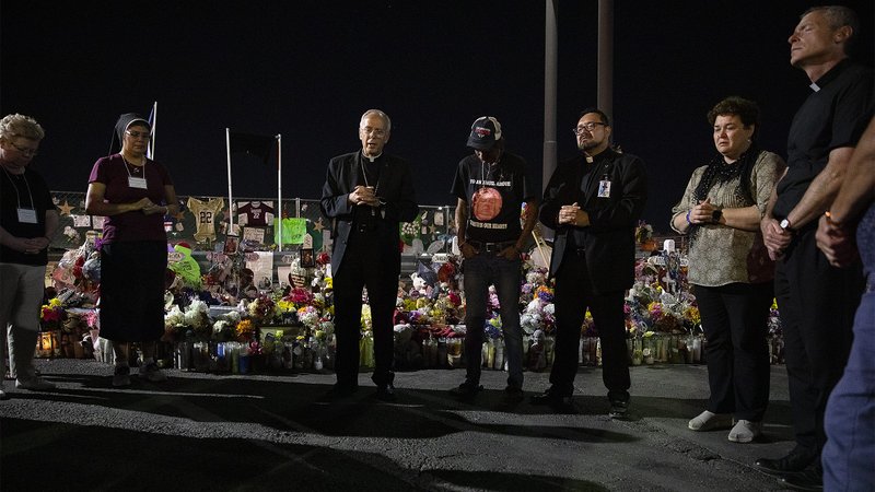 Bishop Mark J. Seitz and Father Fabian Marquez, both of El Paso, Texas, lead prayers Sept. 26, 2019, for Antonio Basco, who lost his wife, Margie Reckard, during the Aug. 3 Walmart mass shooting in El Paso. (CNS photo/Tyler Orsburn)