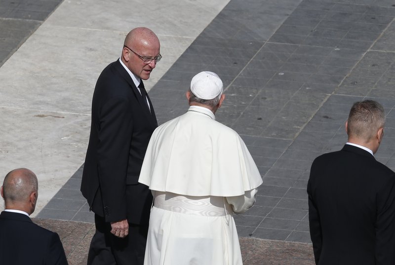 Pope Francis talks with Domenico Giani, his lead bodyguard and head of the Vatican police force, at the conclusion of a canonization Mass in St. Peter's Square at the Vatican Oct. 13, 2019. The pope accepted Giani's resignation Oct. 14, nearly two weeks after an internal security notice was leaked to the Italian press. (CNS photo/Paul Haring)