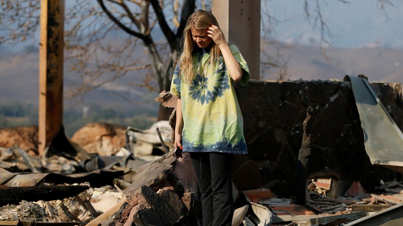 Ashley LaFranchi walks amid rubble of a home Oct. 28, 2019, destroyed by the wind-driven Getty Fire in Calistoga, Calif. By Oct. 29, the fire had burned more than 600 acres and was 5% contained, according to the Los Angeles Fire Department. Several neighborhoods were under evacuation orders, and at least eight homes had been destroyed. (CNS photo/Stephen Lam, Reuters)