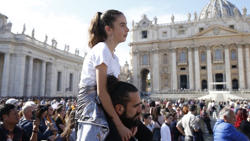 People watch as Pope Francis leads the Angelus from the window of his studio overlooking St. Peter's Square at the Vatican Nov. 1, 2019, the feast of All Saints. (CNS photo/Paul Haring)