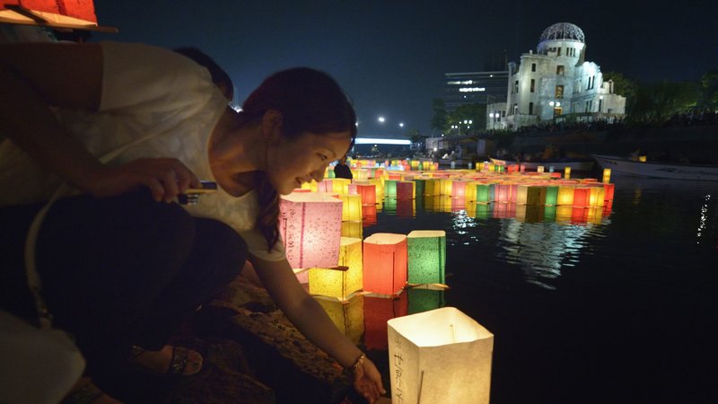 A woman sets a floating candle lantern on the river Aug. 6, 2015, in Hiroshima, Japan, in observance of the 70th anniversary of the atomic bombing of the city. Pope Francis' top aide made no secret of what will be on the pope's mind when he visits Hiroshima and Nagasaki, Japan, Nov. 24: "the total elimination of nuclear weapons." (CNS photo/Paul Jeffrey)
