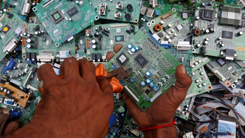 A man in Karachi, Pakistan, retrieves circuit boards from discarded computer monitors Aug. 16, 2017. An economic system lacking any ethics leads to a "throwaway" culture of consumption and waste, Pope Francis said in a speech addressed to members of the Council for Inclusive Capitalism during an audience at the Vatican Nov. 11. (CNS photo/Akhtar Soomro, Reuters)