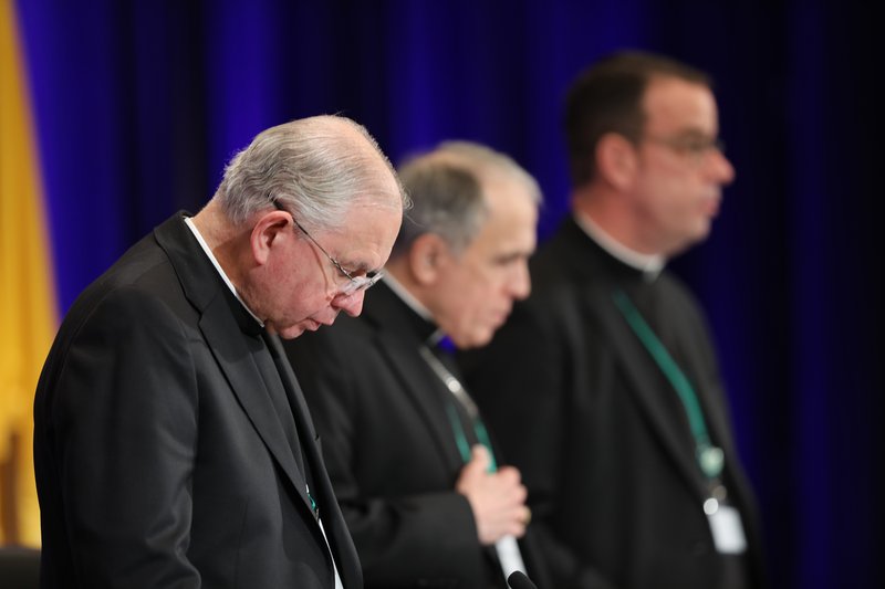 Archbishop Jose H. Gomez of Los Angeles, vice president of the U.S. Conference of Catholic Bishops, Cardinal Daniel N. DiNardo of Galveston-Houston, president, and Msgr. J. Brian Bransfield, general secretary, pray during the the fall general assembly of the USCCB in Baltimore Nov. 11, 2019. (CNS photo/Bob Roller)