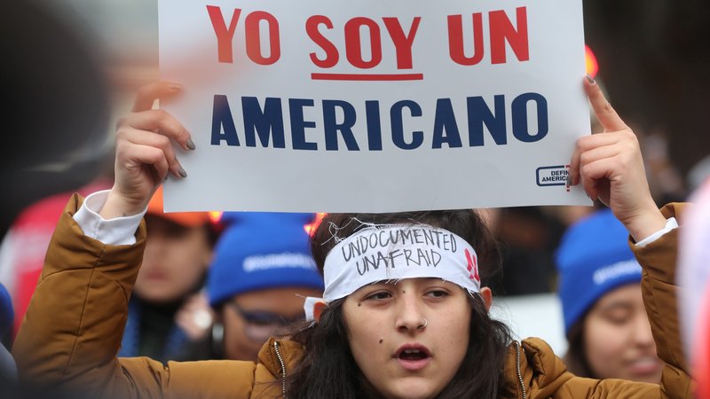 A DACA demonstrator hold a sign outside the U.S. Supreme Court in Washington Nov. 12, 2019, as justices hear oral arguments regarding a legal challenge to the Trump administration's bid to end the Deferred Action for Childhood Arrivals. The placard reads, "I am an American." (CNS photo/Jonathan Ernst, Reuters)
