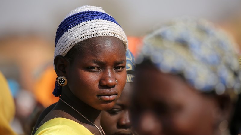 A displaced woman in Dablo, Burkina Faso, looks on while she waits for help March 1, 2019. (CNS photo/Luc Gnago, Reuters)