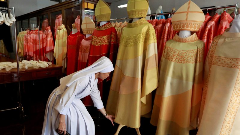 Sister Sukanya Sukchai shows newly made chasubles for Pope Francis Nov. 12, 2019, at a Catholic preparatory school in Bangkok. The pope will visit Thailand Nov. 20-23 to celebrate the 350th anniversary of the establishment of the Apostolic Vicariate of Siam Mission, the first Catholic jurisdiction in what was to become Thailand. (CNS photo/Soe Zeya Tun, Reuters)