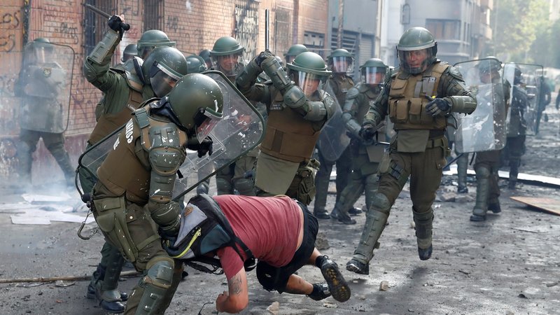 Police in Santiago, Chile, clash with a demonstrator Nov. 14, 2019, during a protest against Chile's government. Chile's bishops Nov. 9 called for national dialogue and an end to the violence that has wracked the country for a month. (CNS photo/Goran Tomasevic, Reuters)
