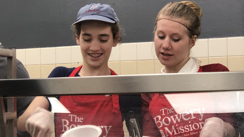 Members of the Warriors, a youth-led service group from the Basilica of St. Patrick's Old Cathedral in New York City, are pictured serving dinner earlier this year at the Bowery Mission, which provides food for those in need in New York City. Working with these young people is a personal calling for Jeannie Gaffigan, co-writer and producer of comedy specials, two books and a television series with her husband and business partner, Jim Gaffigan. (CNS photo/courtesy Warriors youth group)