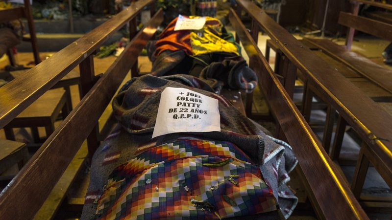 Two bodies lie covered on a bench in St. Francis Church in El Alto, Bolivia, Nov. 20, 2019, after protesters started to bring corpses into the church. The people were killed in clashes between Bolivia's military and supporters of former President Evo Morales. (CNS photo/Marcelo Perez del Carpio)